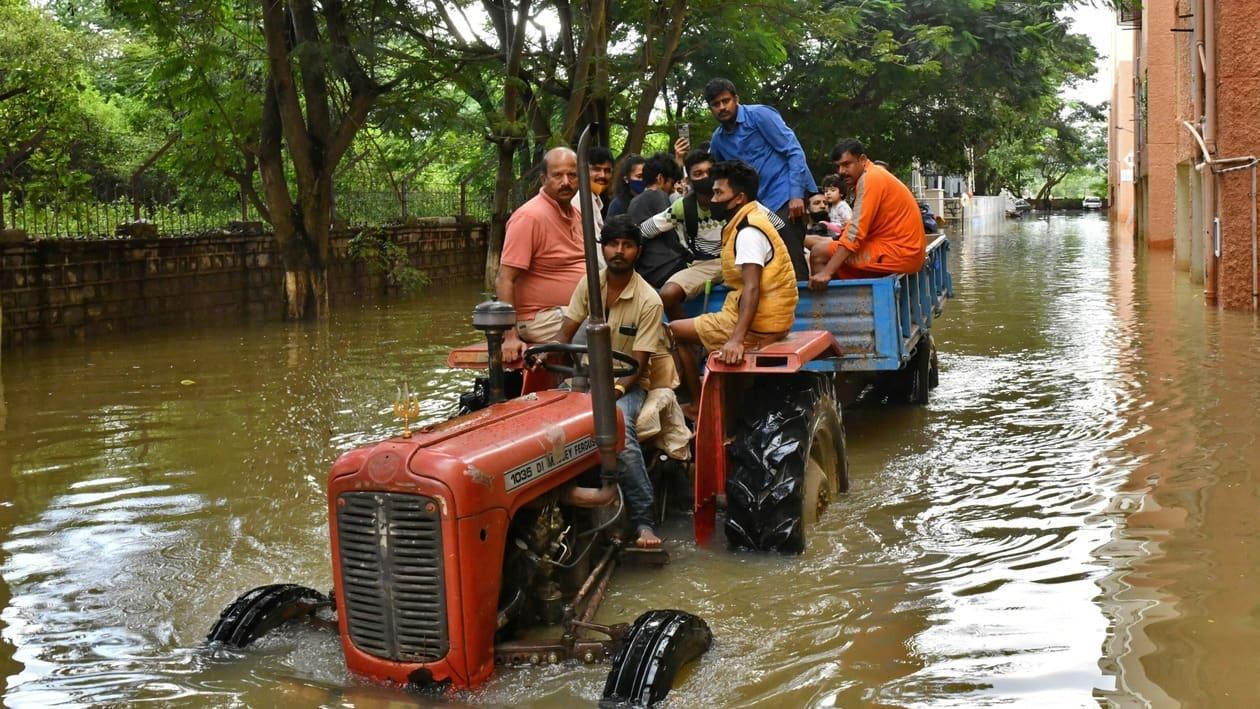 FILE PHOTO: Residents are evacuated to safer places in a tractor trolley after heavy rains caused flooding in a residential area in Bengaluru, India, November 22, 2021. REUTERS/Samuel Rajkumar/File Photo