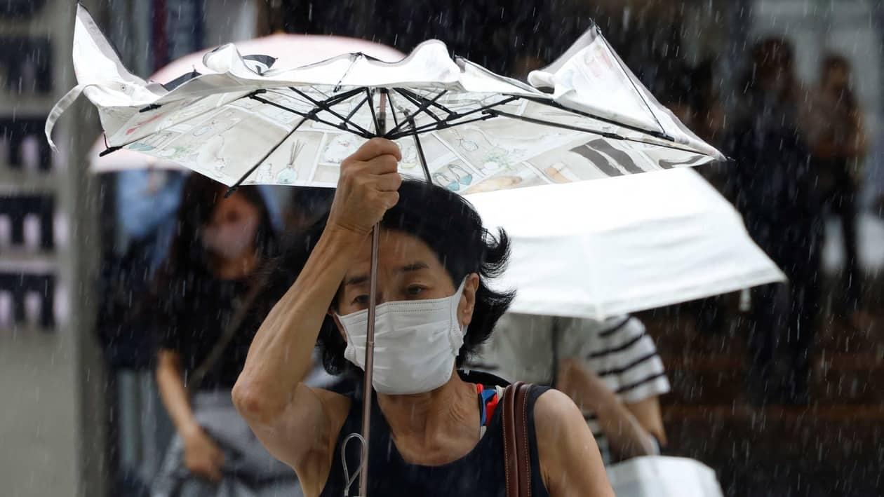 A woman makes her way in the rain caused by typhoon Nanmadol in Tokyo, Japan September 20, 2022. REUTERS/Kim Kyung-Hoon