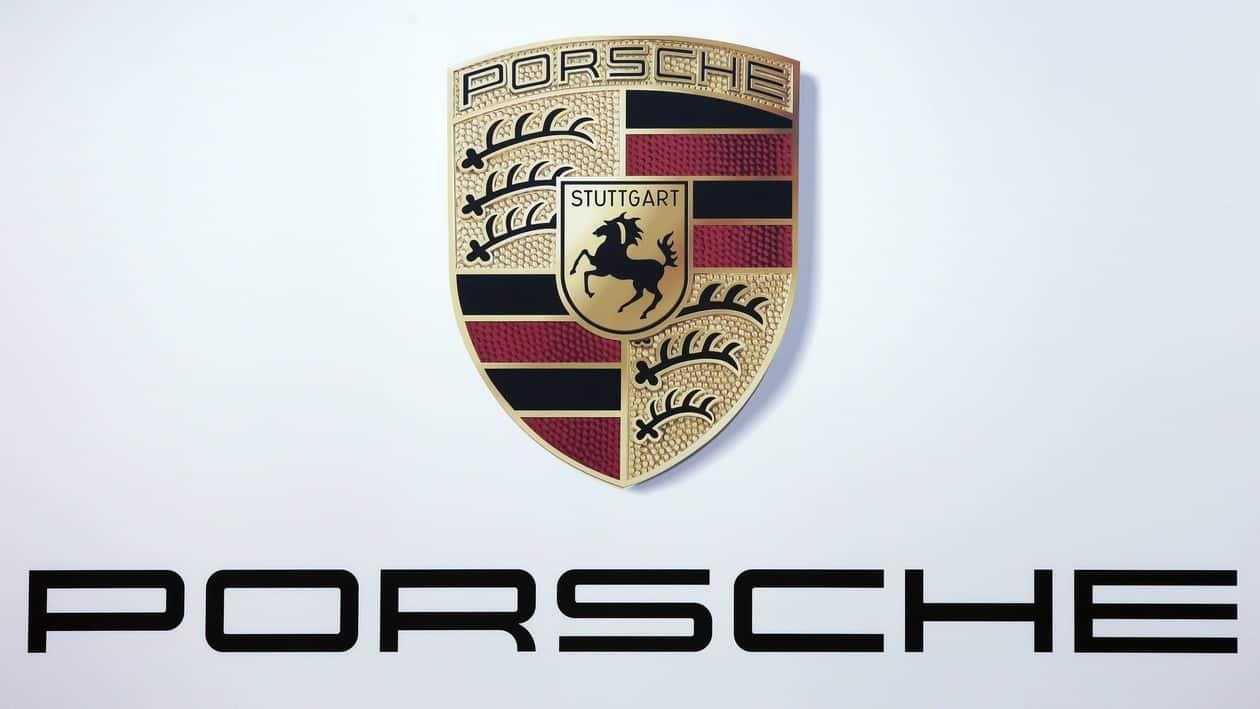 FILE - Logo of the Porsche car manufacturer during the annual shareholders meeting of the Volkswagen stock company in Hannover, Germany, May 10, 2017. Volkswagen has set the price range for the multibillion-euro sale of a minority stake in luxury brand Porsche as its prepares an initial public offering to fund VW's investments in new technologies and businesses including electric cars, software and services. (AP Photo/Michael Sohn)