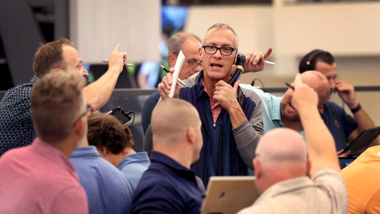 CHICAGO, ILLINOIS - SEPTEMBER 21: Traders signal offers in the S&P options pit at the Cboe Global Markets exchange as the Federal Reserve announced it was raising interest rates on September 21, 2022 in Chicago, Illinois. The Fed today announced a third-straight three-quarter-point rate hike in an attempt to reign in inflation.   Scott Olson/Getty Images/AFP