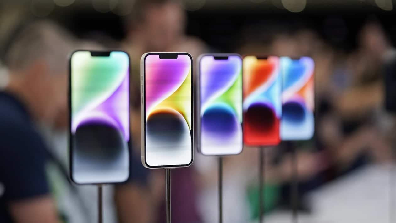 FILE- New iPhone 14 models on display at an Apple event on the campus of Apple's headquarters in Cupertino, Calif., Sept. 7, 2022. Apple Inc. will manufacture its latest iPhone 14 in India, the company said on Monday, as it seeks to curb its production in China. (AP Photo/Jeff Chiu, File)