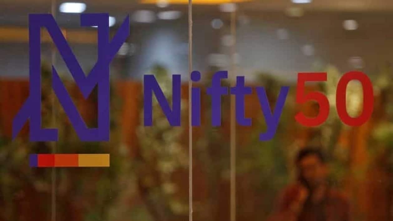FILE PHOTO: A man speaks on his mobile phone past a new brand identity for Nifty Indices inside the National Stock Exchange (NSE) building in Mumbai, India, May 28, 2019. REUTERS/Francis Mascarenhas