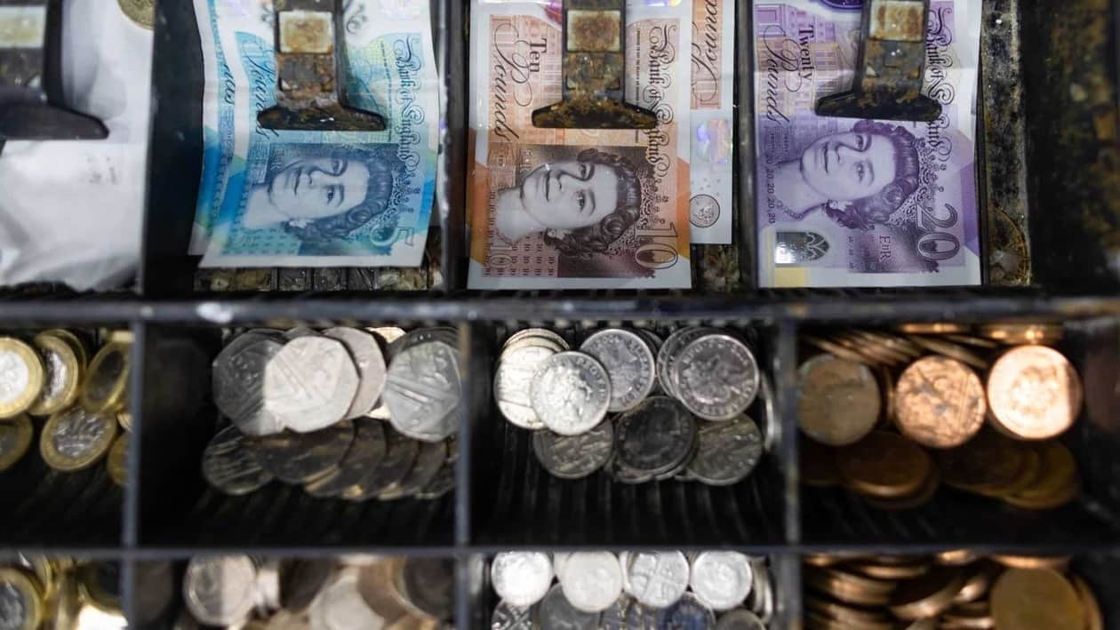 A cash tray holding British pound banknotes and coins in a shop in Barking, UK, on Tuesday, Sept. 13, 2022. As the UK enters a period of public mourning after the death of Queen Elizabeth II, data releases are likely to show a temporary reprieve in inflation and a jump in wage growth. Photographer: Chris Ratcliffe/Bloomberg