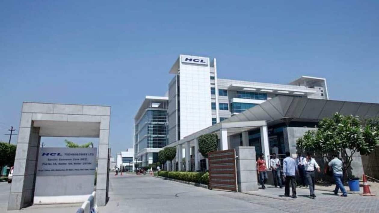 FILE PHOTO: People walk in front of the HCL Technologies Ltd office at Noida, on the outskirts of New Delhi April 17, 2013.  REUTERS/Mansi Thapliyal/File Photo