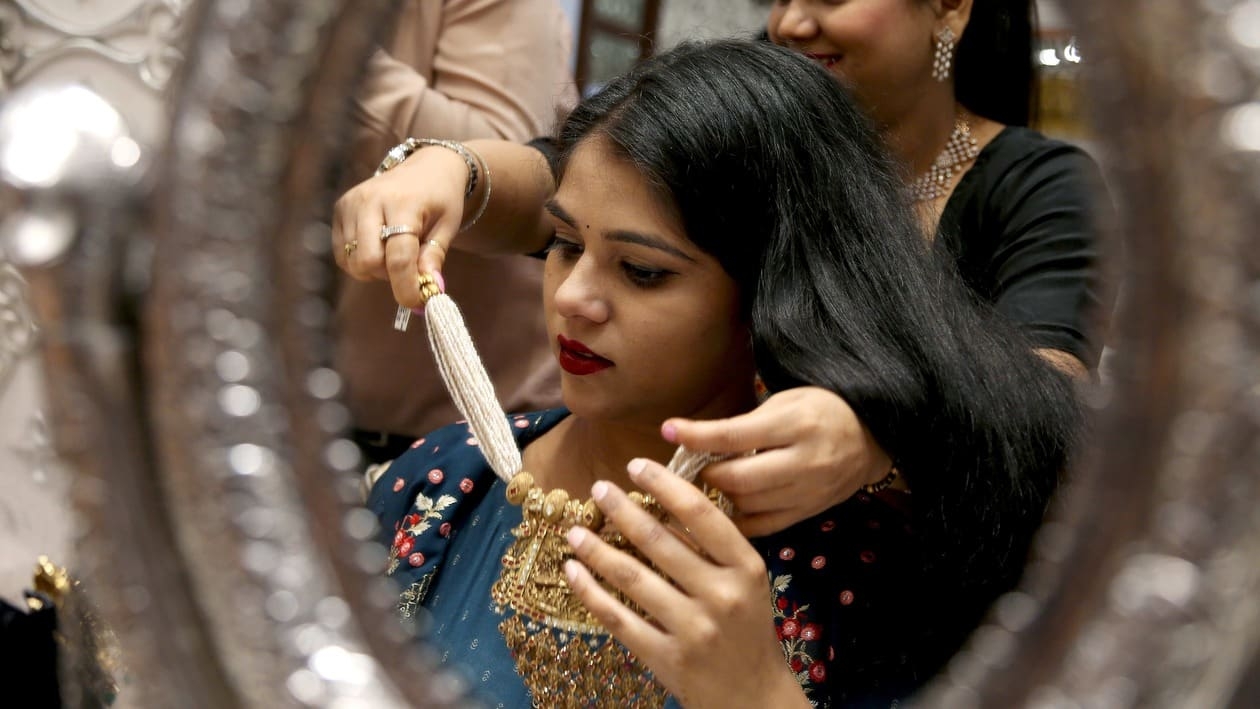 New Delhi, Oct 22 (ANI): A woman choosing gold jewellery on the occasion of Dhanteras festival at Karol Bagh, in New Delhi on Saturday. (ANI Photo)