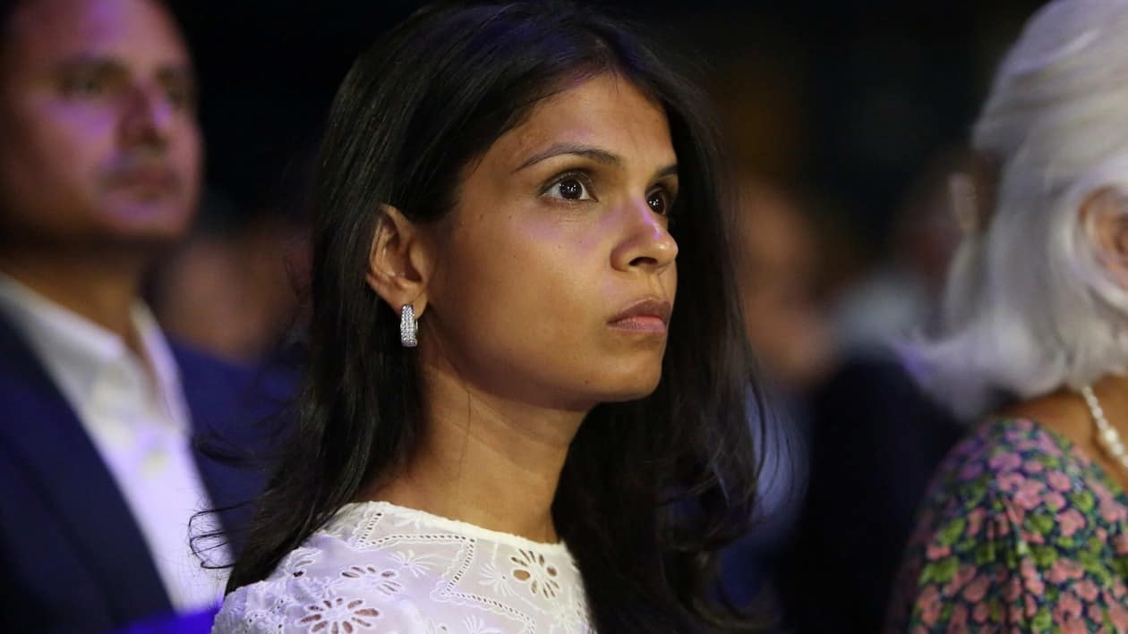 Akshata Murthy listens as her husband Rishi Sunak (unseen), Britain's former Chancellor of the Exchequer and a contender to become the country's next Prime Minister and leader of the Conservative party, answers questions as he takes part in the final Conservative Party Hustings event at Wembley Arena, in London, on August 31, 2022. (Photo by Susannah Ireland / AFP)