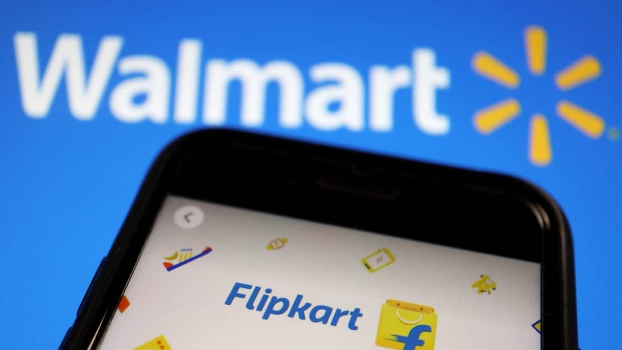 FILE PHOTO: A mobile phone showing an image of Indian online retailer Flipkart is seen in front of a Walmart Inc logo displayed in this illustration picture taken July 14, 2021. REUTERS/Florence Lo/Illustration/File Photo