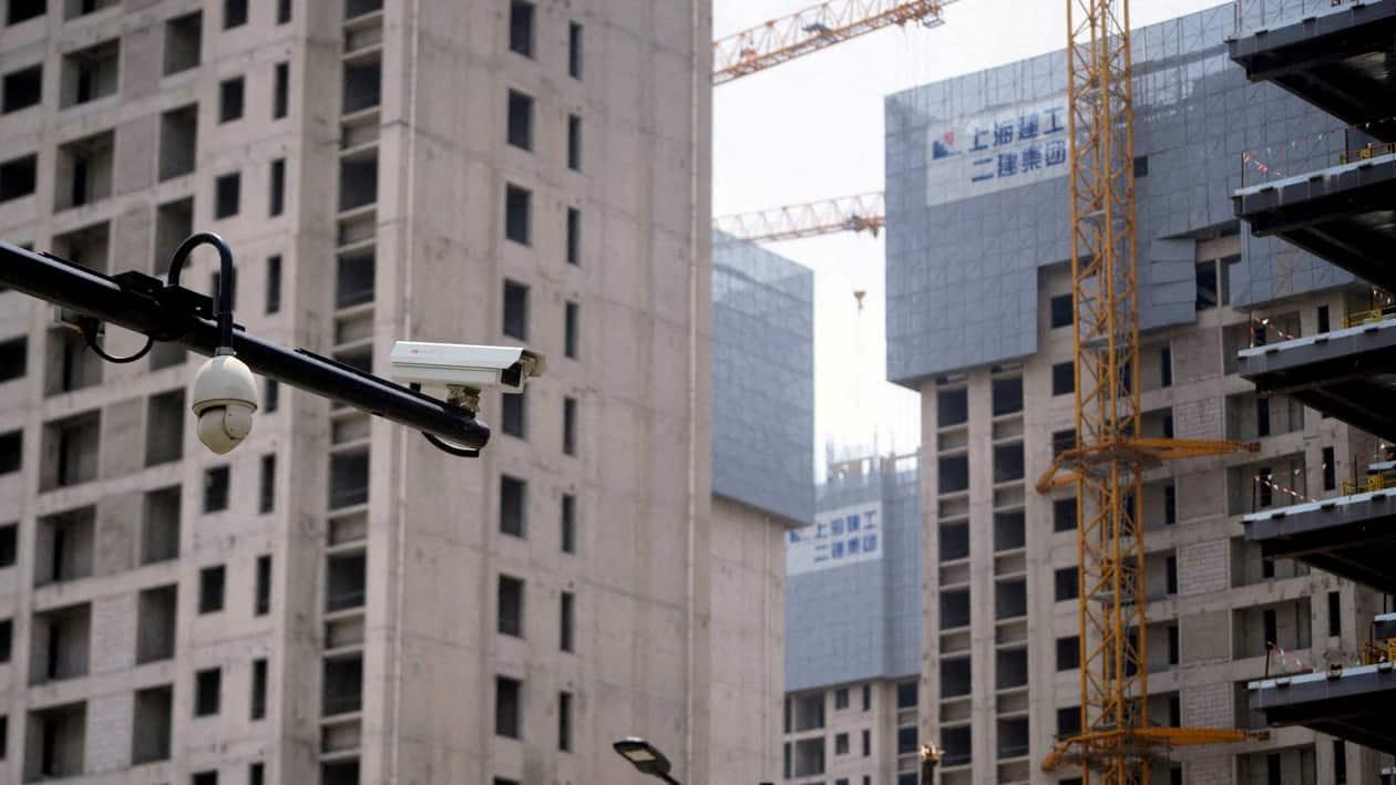 FILE PHOTO: Surveillance cameras are seen near residential buildings under construction in Shanghai, China July 20, 2022. REUTERS/Aly Song/File Photo