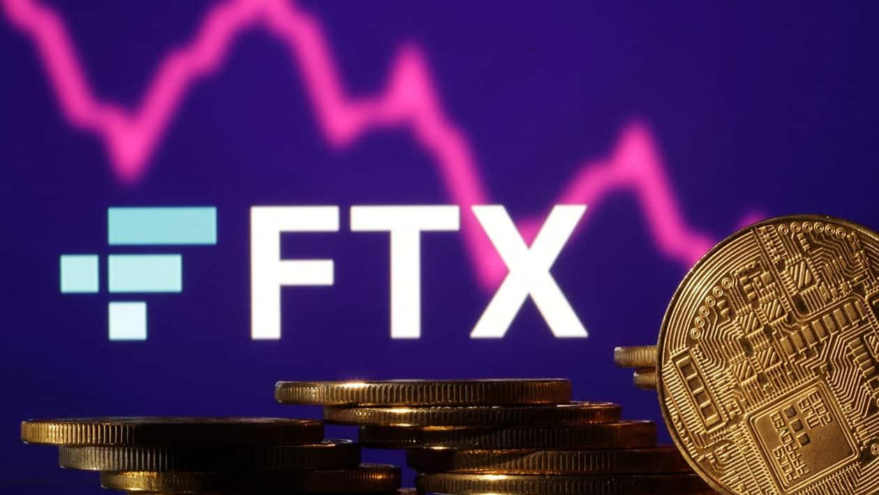 Representations of cryptocurrencies are seen in front of displayed FTX logo and decreasing stock graph in this illustration taken November 10, 2022. REUTERS/Dado Ruvic/Illustration