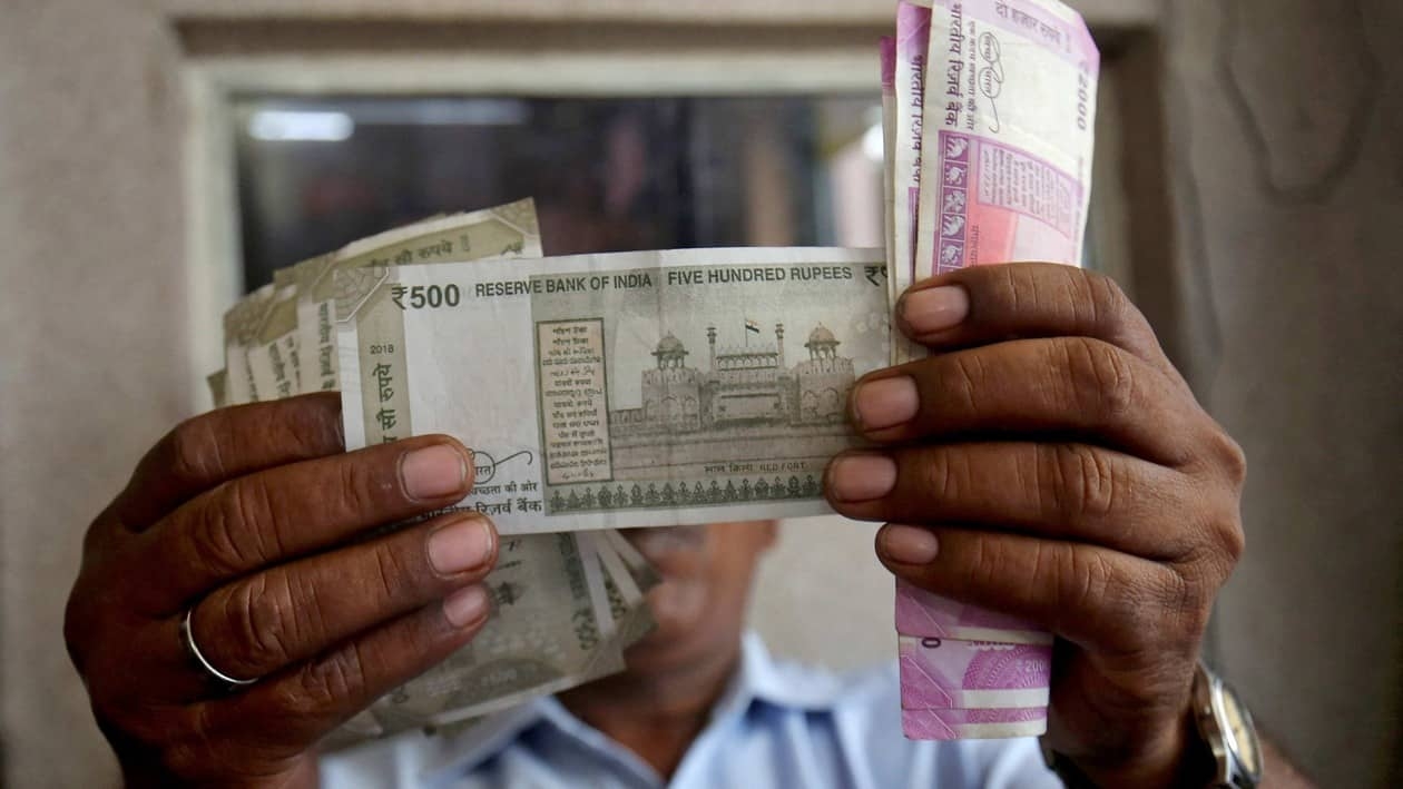 FILE PHOTO: A cashier checks Indian rupee notes inside a room at a fuel station in Ahmedabad, India, September 20, 2018. REUTERS/Amit Dave/File Photo