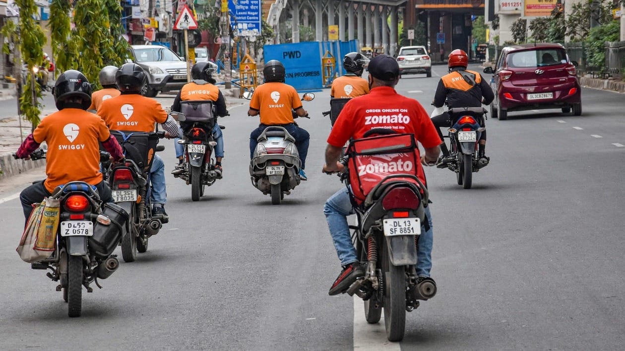 New Delhi: In this Tuesday, March 31, 2020 file photo, deliverymen of food aggregators Swiggy and Zomato ride on their bikes towards their destinations during the nationwide lockdown, imposed in the wake of coronavirus pandemic, in New Delhi. (PTI Photo)(PTI10_21_2022_000115A)