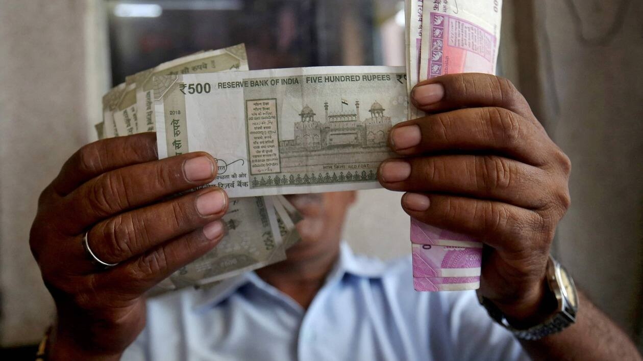 FILE PHOTO: A cashier checks Indian rupee notes inside a room at a fuel station in Ahmedabad, India, September 20, 2018. REUTERS/Amit Dave/File Photo