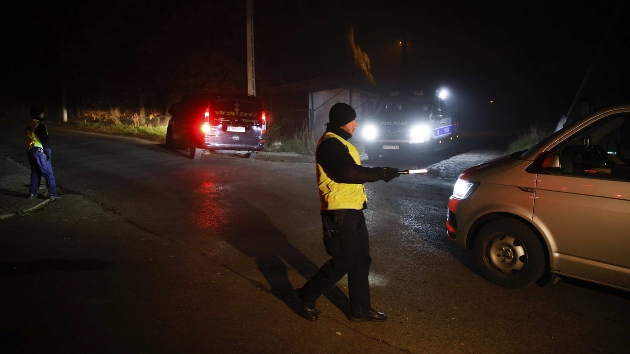A police officer checks a vehicle outside a grain depot where, according to the Polish government, an explosion of a Russian-made missile killed two people, in Przewodow, eastern Poland, Tuesday, Nov. 15, 2022. Poland said early Wednesday that a Russian-made missile fell in the eastern part of the country, killing two people in a blast that marked the first time since the invasion of Ukraine that Russian weapons came down on a NATO country. (AP Photo/Michal Dyjuk)