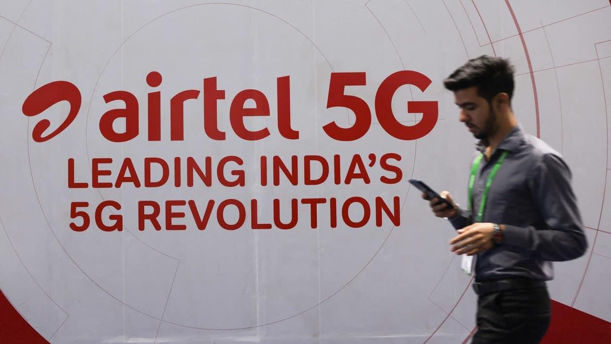 A man walks across a board showing the logo of Airtel at the ongoing India Mobile Congress 2022, at Pragati Maidan, in New Delhi, India, October 3, 2022. REUTERS/Anushree Fadnavis