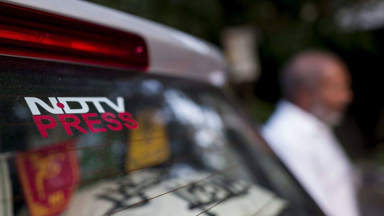 Signage of the New Delhi Television Ltd. (NDTV) on a car parked inside a parking compound in New Delhi, India, on Monday, Sept. 5, 2022. Adani Group, indirectly�acquired�a 29.2% stake in�New Delhi Television Ltd., or NDTV, and offered to buy another 26% from the open market for a combined 6.07 billion rupees ($76 million) in August 2022. Photographer: Anindito Mukherjee/Bloomberg