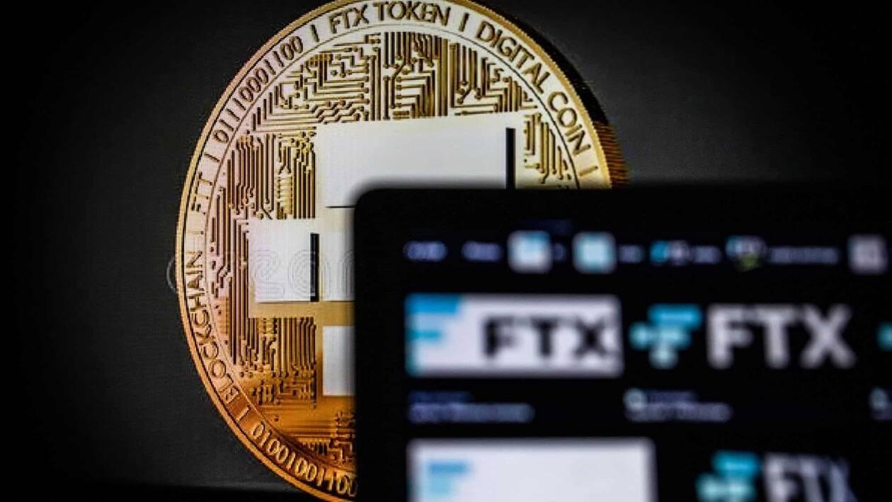 A coin representing Bitcoin cryptocurrency beyond FTX logos on a laptop computer arranged in Barcelona, Spain, on Tuesday, Nov. 15, 2022. FTX Group named a�slate�of new independent directors to oversee the collapsed crypto empire and said its bankruptcy may involve more than a million creditors. Photographer: Angel Garcia/Bloomberg