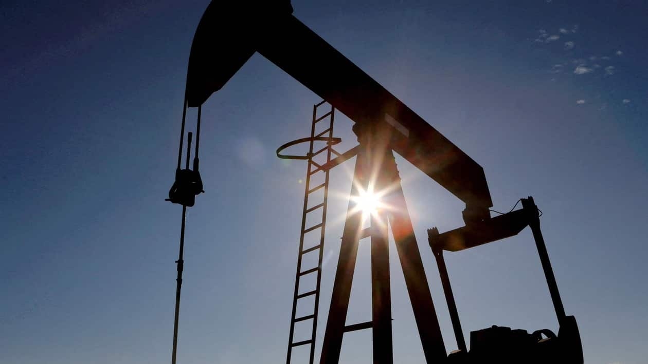 FILE PHOTO: The sun is seen behind a crude oil pump jack in the Permian Basin in Loving County, Texas, U.S., November 22, 2019. REUTERS/Angus Mordant/File Photo/File Photo