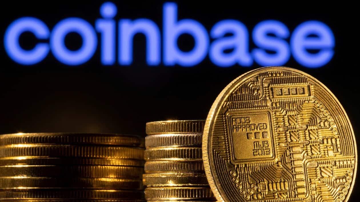 FILE PHOTO: A representation of the cryptocurrency is seen in front of Coinbase logo in this illustration taken, March 4, 2022. REUTERS/Dado Ruvic/Illustration/File Photo