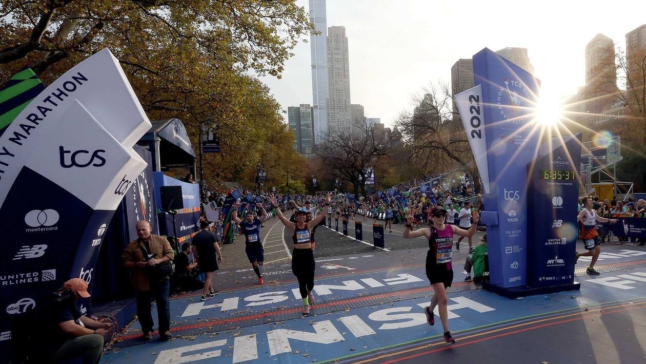 NEW YORK, NEW YORK - NOVEMBER 06: Runners cross the finish line of the TCS 2022 New York City Marathon on November 06, 2022 in New York City.   Jamie Squire/Getty Images/AFP