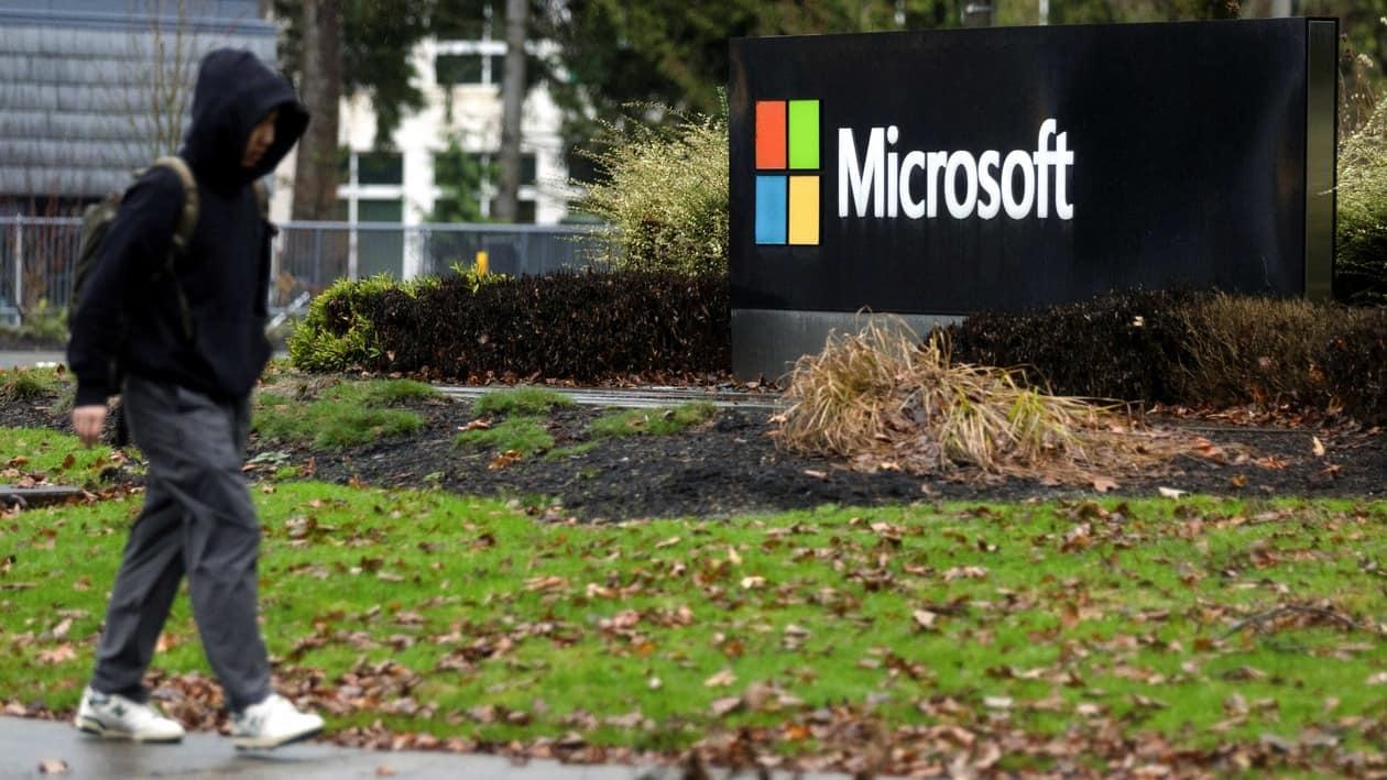 A person walks past Microsoft signage at the headquarters in Redmond, Washington, U.S., January 18, 2023. REUTERS/Matt Mills McKnight