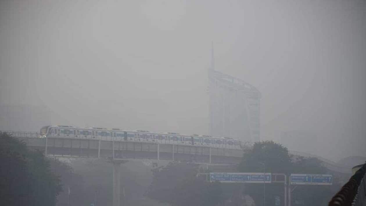 A Rapid Metro train amid dense fog at DLF phase 3 near cyber city Metro station in Gurugram on Tuesday. (Parveen Kumar/HT Photo)