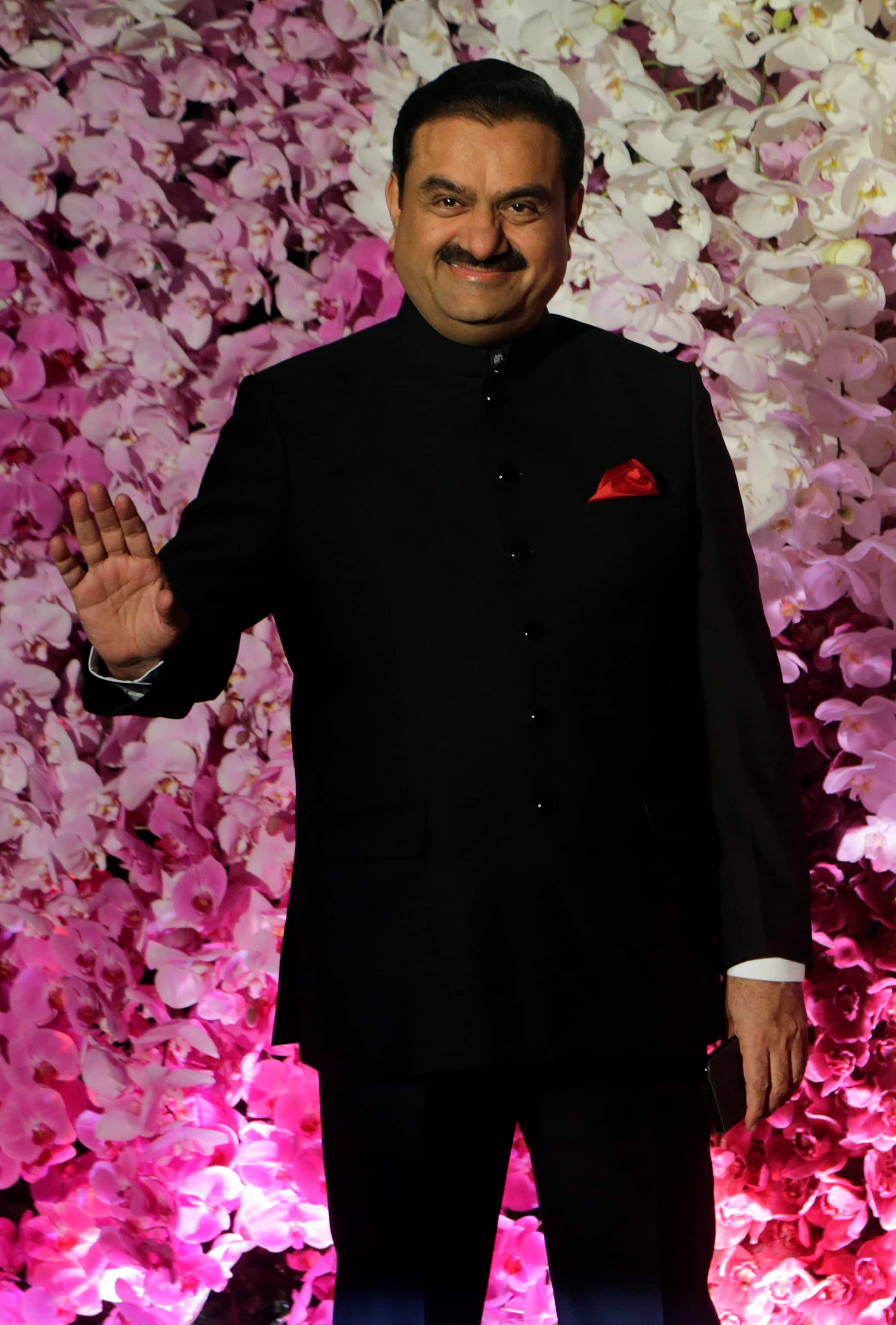FILE- Adani Group Gautam Chairman Gautam Adani poses during Akash Ambani's wedding reception in Mumbai, India, March 10, 2019. Asia’s richest man, Gautam Adani, made his vast fortune betting on coal as an energy hungry India grew swiftly after liberalizing its economy in the 1990s. He's now set his sights on becoming world's biggest renewable energy player, by 2030, adroitly aligning his investments with the government’s own priorities. (AP Photo/Rajanish Kakade, File)