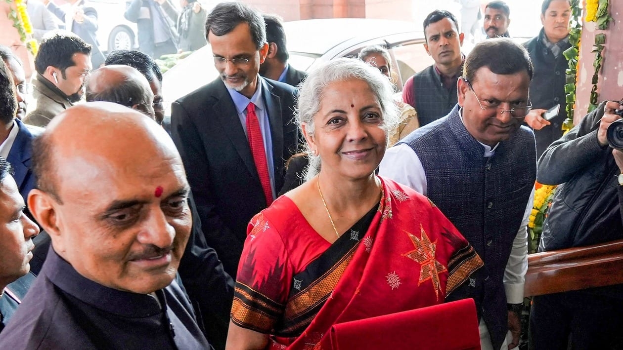 New Delhi: Union Finance Minister Nirmala Sitharaman, flanked by Ministers of State Bhagwat Kishanrao Karad and Pankaj Chaudhary, shows a folder-case containing her Union Budget 2023-24 speech as she arrives at Parliament, in New Delhi, Wednesday, Feb. 1, 2023. Sitharaman will be presenting her fifth Union Budget. (PTI Photo/Kamal Singh)   (PTI02_01_2023_RPT099A)