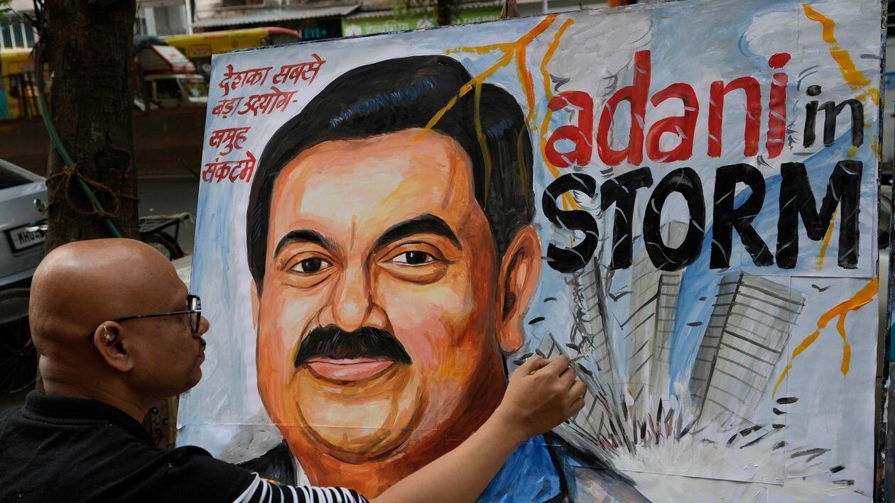Sagar Kambli, an artist and a school teacher, gives final touches to a painting of Indian businessman Gautam Adani, depicting the ongoing crisis of the Adani group, in Mumbai, India, Friday, Feb. 3, 2023. Losses for the troubled Adani Group, India's second-largest conglomerate, deepened on Friday as shares in its flagship company tumbled another 25%, extending over a week of declines that have wiped out tens of billions of dollars in market value. (AP Photo/Rajanish Kakade)