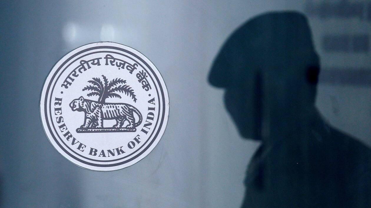 FILE PHOTO: A security guard's reflection is seen next to the logo of the Reserve Bank Of India (RBI) at the RBI headquarters in Mumbai, India, June 6, 2019. REUTERS/Francis Mascarenhas/File Photo