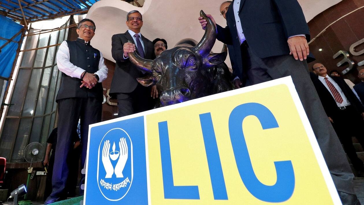 FILE PHOTO: Ashishkumar Chauhan, MD and CEO of Bombay Stock Exchange (BSE), Life Insurance Corporation of India (LIC) Chairperson Mangalam Ramasubramanian Kumar and Tuhin Kanta Pandey, Secretary Department of Investment and Public Asset Management (DIPAM), pose with a bronze replica of the Charging Bull of Wall Street, after the company's IPO listing ceremony at the Bombay Stock Exchange (BSE) in Mumbai, India, May 17, 2022. REUTERS/Niharika Kulkarni/File Photo