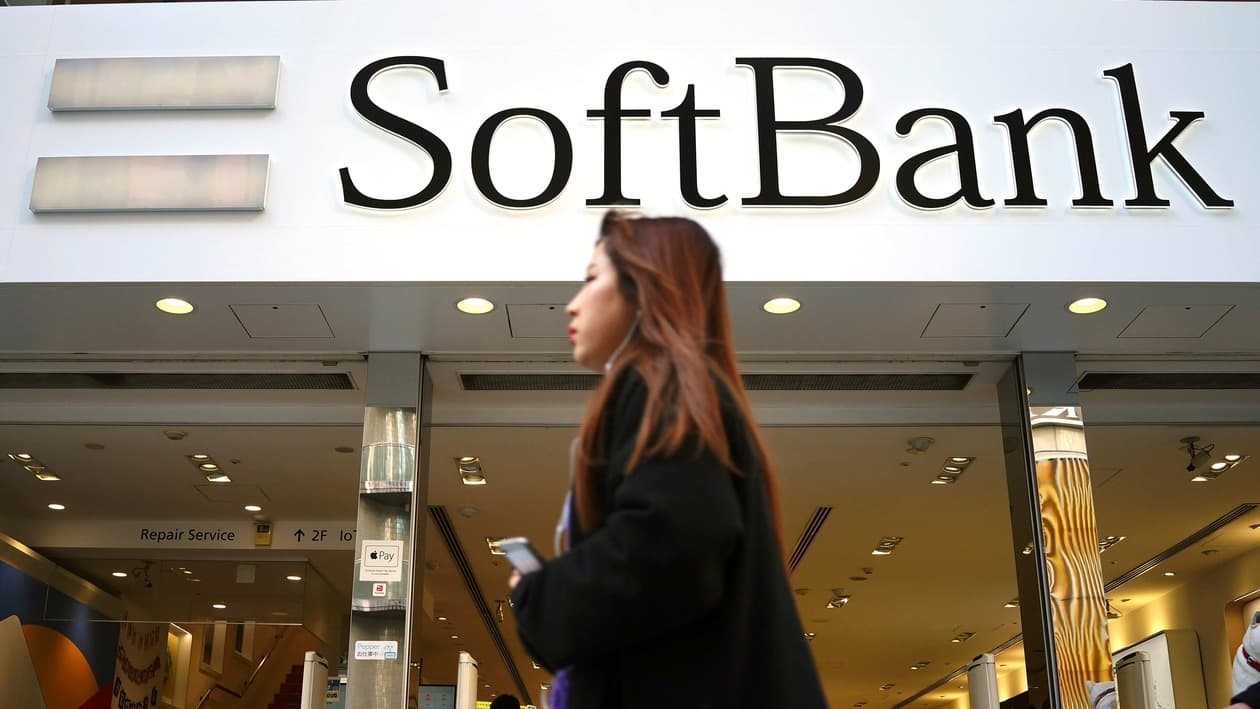 A woman walks in front of SoftBank store in Ginza shopping district in Tokyo, Jan. 20, 2020. Japanese investor SoftBank Group reported Tuesday, Feb. 7, 2023 that it sank into a deep loss for the October-December quarter, slammed by the global plunge in technology shares. (AP Photo/Eugene Hoshiko)