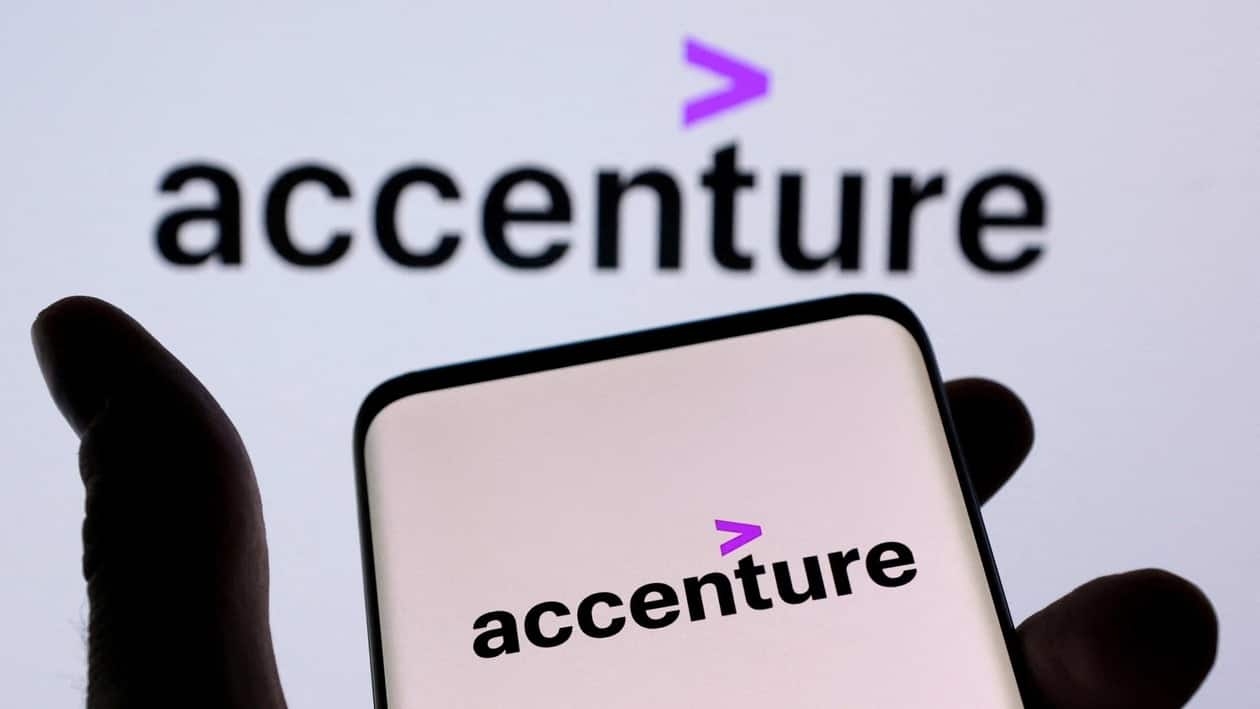 FILE PHOTO: Accenture PLC logo is seen on a smartphone in front of displayed same logo in this illustration taken, December 1, 2021. REUTERS/Dado Ruvic/Illustration/File Photo