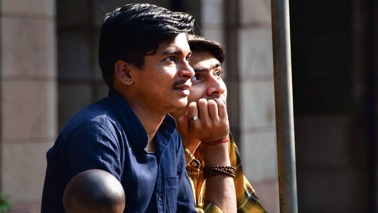 Mumbai: People look at Sensex updates on a screen outside the Bombay Stock Exchange (BSE) building, in Mumbai, Friday, Jan. 27, 2023. Equity benchmarks Sensex and Nifty plunged over 1 per cent for a second straight session on Friday, Jan. 27, 2023. (PTI Photo)(PTI01_27_2023_000241B)