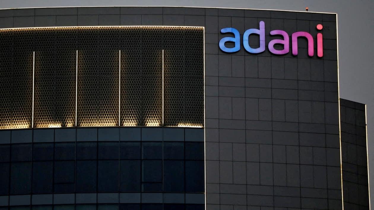 FILE PHOTO: The logo of the Adani group is seen on the facade of one of its buildings on the outskirts of Ahmedabad, India, April 13, 2021. REUTERS/Amit Dave/File Photo